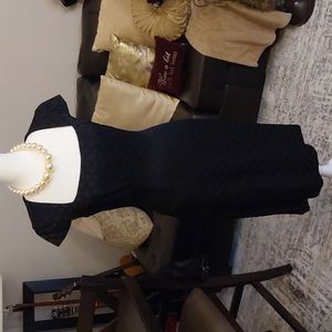 Black nine west dress with circle pattern and cap sleeves.
